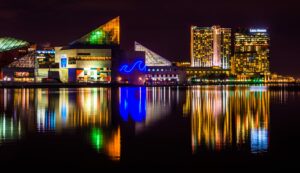 November's Fun-Filled Adventures Near FanAtlas Baltimore! A city building stands tall, mirrored in the tranquil waters nearby.