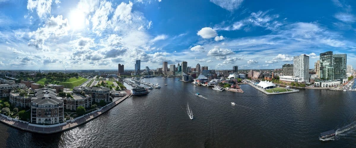 Aerial panoramic view of Baltimore Inner Harbor showing proximity to Oriole Park at Camden Yards with downtown Baltimore skyline and waterfront where Harbor Park Garage offers affordable Camden Yards parking