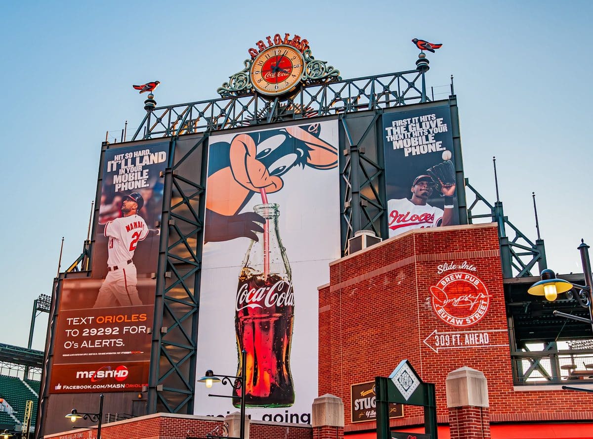 The iconic Orioles scoreboard with clock and Oriole Bird statues at Camden Yards